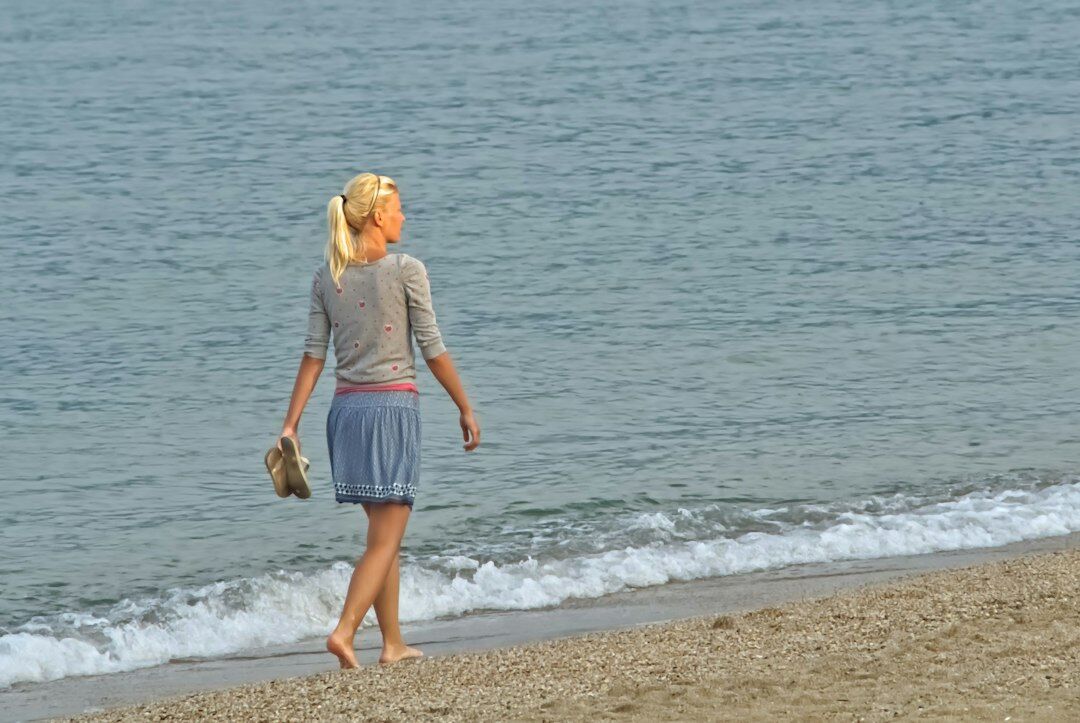 woman walking alone on beach