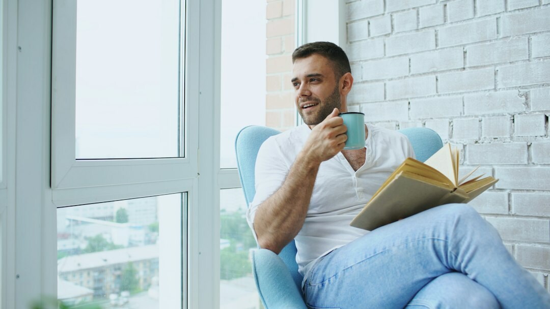 person reading book at home