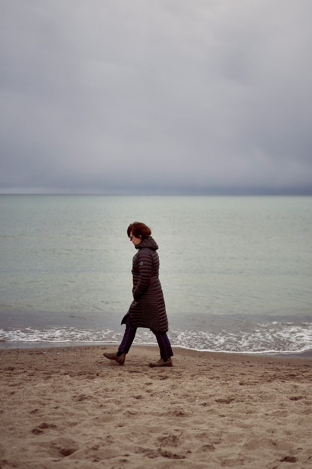 woman walking alone on beach